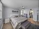 Bedroom features hardwood floors, ceiling fan, and ensuite bath at 7910 Sun Island S Dr # 301, South Pasadena, FL 33707