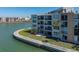 Exterior of building with waterfront view and patios on each level at 7910 Sun Island S Dr # 301, South Pasadena, FL 33707