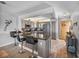 Eat-in kitchen features a breakfast bar, modern appliances, and stylish gray cabinetry at 7910 Sun Island S Dr # 301, South Pasadena, FL 33707