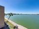 Stunning water view from the property showcasing clear skies and tropical palm trees along the waterfront at 7910 Sun Island S Dr # 301, South Pasadena, FL 33707