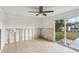 Light filled living room with sliding glass door and tiled floors, ready for renovation at 104 Carlyle Cir, Palm Harbor, FL 34683