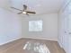 Bedroom featuring hardwood floors, a ceiling fan, a window, and a closet at 10538 Lucaya Dr, Tampa, FL 33647