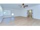 Spacious living room with plenty of natural light, a ceiling fan, and hardwood flooring at 10538 Lucaya Dr, Tampa, FL 33647