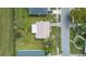 Aerial view of the home showing the roof, yard, driveway, and surrounding neighborhood at 10701 41St N Ct, Clearwater, FL 33762