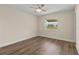 Bedroom with hardwood floors, a window overlooking the yard, and neutral paint at 10701 41St N Ct, Clearwater, FL 33762