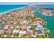 Stunning aerial view of a waterfront community with beautiful homes and boat access to the ocean at 115 16Th St, Belleair Beach, FL 33786