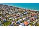 Breathtaking aerial view of coastal neighborhood with lush landscaping and turquoise water at 115 16Th St, Belleair Beach, FL 33786