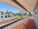 Relaxing balcony showcasing water views and tropical landscaping at 115 16Th St, Belleair Beach, FL 33786