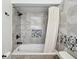 Bathroom featuring marble tile, shower, and a built-in niche at 115 16Th St, Belleair Beach, FL 33786