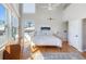 Bright bedroom featuring a high ceiling, large windows for ample natural light, and neutral decor at 115 16Th St, Belleair Beach, FL 33786