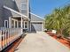 Well-maintained home with a spacious driveway, two-car garage, and mature landscaping at 115 16Th St, Belleair Beach, FL 33786