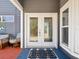 Elegant entryway featuring a stylish double door and adjacent window enhancing natural light at 115 16Th St, Belleair Beach, FL 33786