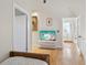 Hallway with hardwood floors leading to a bedroom and bathroom at 115 16Th St, Belleair Beach, FL 33786