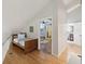 Hallway with hardwood floors leading to a bedroom and bathroom at 115 16Th St, Belleair Beach, FL 33786
