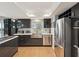 Modern kitchen featuring stainless steel appliances, sleek cabinetry, and a stylish backsplash at 115 16Th St, Belleair Beach, FL 33786