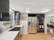Contemporary kitchen showcasing stainless steel appliances, quartz counters, and modern cabinetry at 115 16Th St, Belleair Beach, FL 33786