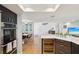 Modern kitchen open to the dining area, featuring stainless steel appliances and hardwood floors at 115 16Th St, Belleair Beach, FL 33786