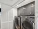 Efficient laundry room with modern front load washer and dryer and ample cabinet storage at 115 16Th St, Belleair Beach, FL 33786