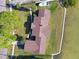 An overhead view shows the brown roof of a home with shoreline and road at 116 Shore Drive Pl, Oldsmar, FL 34677