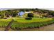 Aerial view of a community park featuring a playground, pavilion, and green spaces near the waterfront, creating a recreational area at 116 Shore Drive Pl, Oldsmar, FL 34677