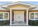 Charming brick home featuring a covered front entrance, double doors, and symmetrically placed windows with white trim at 116 Shore Drive Pl, Oldsmar, FL 34677