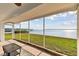 The screened patio boasts a view of the lush backyard and tranquil waterfront at 116 Shore Drive Pl, Oldsmar, FL 34677