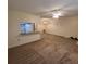 View of open-concept living room showing neutral carpet and kitchen view at 12760 Indian Rocks Rd # 540, Largo, FL 33774