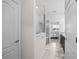 Bright bathroom featuring a glass shower, neutral tile, and access to the main bedroom at 13909 Galway Sand Rd, Riverview, FL 33579