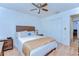 Cozy bedroom featuring hardwood floors, ceiling fan, and ample closet space for comfortable living and organization at 14041 Arbor Knoll Cir, Tampa, FL 33625