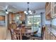 Cozy dining area featuring wood table and chairs, natural light, and seamless kitchen access at 14041 Arbor Knoll Cir, Tampa, FL 33625