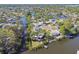 An aerial view highlighting waterfront homes, natural waterways, and lush greenery in a residential neighborhood at 1516 Massachusetts Ne Ave, St Petersburg, FL 33703
