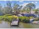 Aerial view of a home with waterfront access, featuring a private dock, screened porch, and spacious backyard at 1516 Massachusetts Ne Ave, St Petersburg, FL 33703