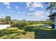 Spacious backyard of waterfront property offers grassy areas, shuffleboard court, and serene views at 1516 Massachusetts Ne Ave, St Petersburg, FL 33703