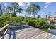A wood dock featuring a built-in bench, bordered by lush greenery with calm water views at 1516 Massachusetts Ne Ave, St Petersburg, FL 33703