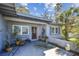 Charming front entrance featuring potted plants and a small patio with light gray exterior at 1516 Massachusetts Ne Ave, St Petersburg, FL 33703