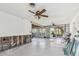 Spacious living room under construction with ceiling fans and a sliding glass door to the outside at 1516 Massachusetts Ne Ave, St Petersburg, FL 33703