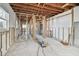 Spacious living room featuring exposed ceiling beams, unfinished walls, and a concrete floor at 1516 Massachusetts Ne Ave, St Petersburg, FL 33703