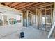 Large open-concept living room with exposed ceiling beams, and partially framed walls at 1516 Massachusetts Ne Ave, St Petersburg, FL 33703