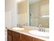 Bathroom featuring dual sinks, large mirror and a bathtub at 1705 Bonita Bluff Ct, Ruskin, FL 33570