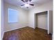 Bedroom with ceiling fan, wood-look flooring, closet and window at 1705 Bonita Bluff Ct, Ruskin, FL 33570