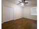 Bright bedroom featuring a ceiling fan and wood-look flooring at 1705 Bonita Bluff Ct, Ruskin, FL 33570