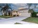 Charming home features a front porch, two-car garage, and well-maintained landscaping at 1705 Bonita Bluff Ct, Ruskin, FL 33570