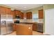 Well-equipped kitchen featuring stainless steel appliances, a kitchen island, and wood cabinetry at 1705 Bonita Bluff Ct, Ruskin, FL 33570