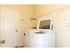 Well-lit laundry room with white washer, dryer, and convenient overhead shelving at 1705 Bonita Bluff Ct, Ruskin, FL 33570