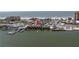 An aerial view showcasing the property's waterfront location near shops, boats, and ocean at 17821 Gulf Blvd # B, Redington Shores, FL 33708