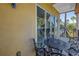 Balcony with an ornate metal table and chairs, and views of palm trees at 17821 Gulf Blvd # B, Redington Shores, FL 33708