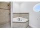 Bathroom featuring a shower and tub with a circular window at 17821 Gulf Blvd # B, Redington Shores, FL 33708