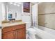 Bathroom with a granite countertop, tile shower with curtain and a built-in bathtub at 17821 Gulf Blvd # B, Redington Shores, FL 33708
