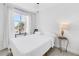 Bright bedroom with white walls, a large window, and a decorative side table lamp at 17821 Gulf Blvd # B, Redington Shores, FL 33708