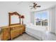 A cozy bedroom with a decorative dresser and mirror, and a balcony with a view at 17821 Gulf Blvd # B, Redington Shores, FL 33708